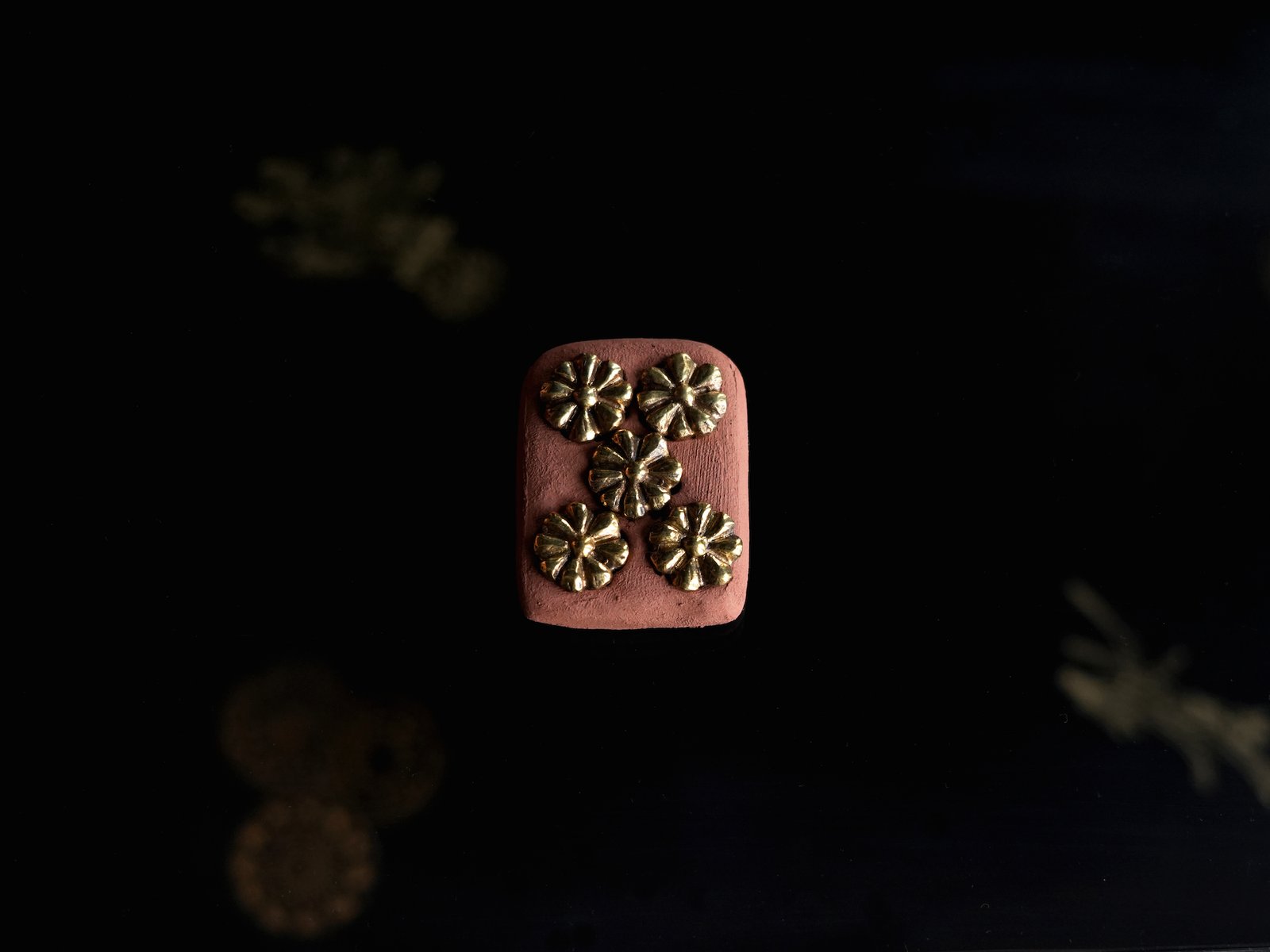flower of life buttons on terracotta setting